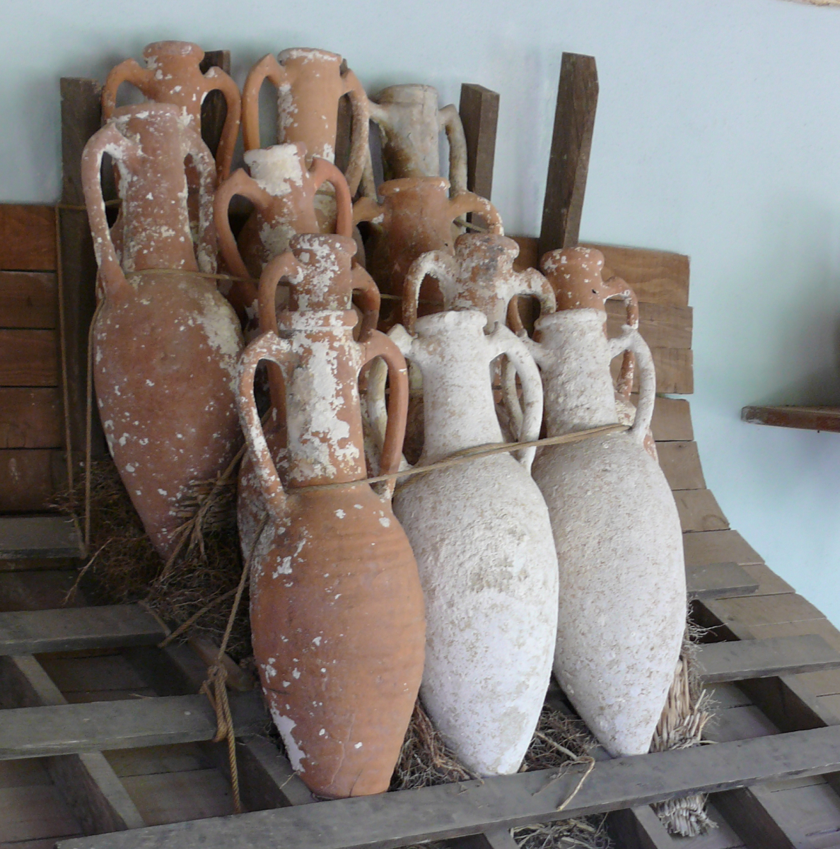 <i>Amphorae</i> designed for marine transport, taken from shipwrecks of the <a href="/content/Bronze_Age" style="color:blue">Bronze Age</a>, on display in the Museum of Underwater Archaeology at <a href="/content/Bodrum_Castle" style="color:blue">Bodrum Castle</a>, <a href="/content/Turkey" style="color:blue">Turkey</a>. The museum archaeologists have devised a rack and roping device to illustrate how the cargo might have been kept from shifting.Below: <a href="/content/Panathenaic_amphora" style="color:blue">Panathenaic prize amphora</a> in the <a href="/content/Black-figure" style="color:blue">black-figure</a> style, showing the goddess <a href="/content/Athena" style="color:blue">Athena</a>