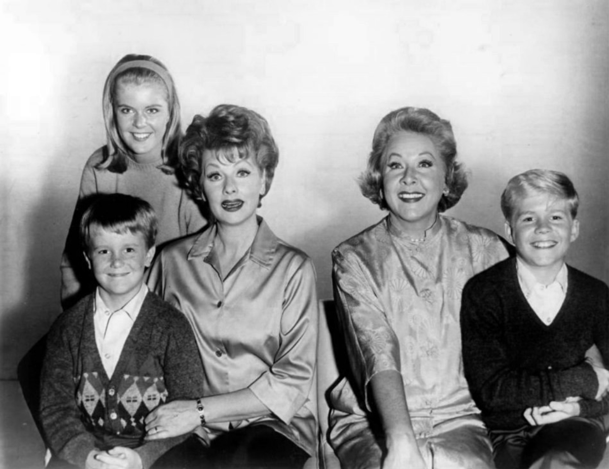 Cast of <i><a href="/content/The_Lucy_Show" style="color:blue">The Lucy Show</a></i> during its first three seasons: Candy Moore (in back); front, L-R: Jimmy Garrett, <a href="/content/Lucille_Ball" style="color:blue">Lucille Ball</a>, <a href="/content/Vivian_Vance" style="color:blue">Vivian Vance</a>, and Ralph Hart (1962)
