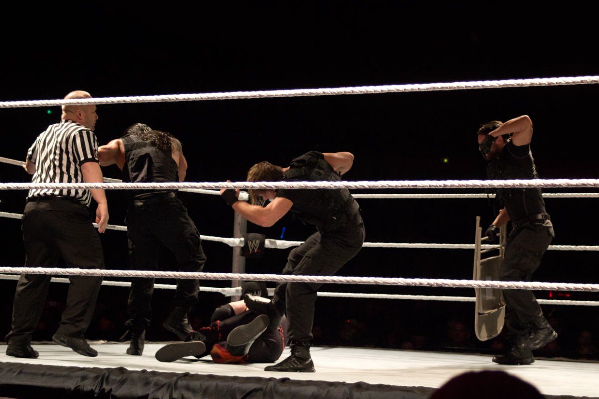 <a href="/content/The_Shield_(professional_wrestling)" style="color:blue">The Shield</a> performing a <a href="/content/down" style="color:blue">beat down</a> on <a href="/content/Kane_(wrestler)" style="color:blue">Kane</a>