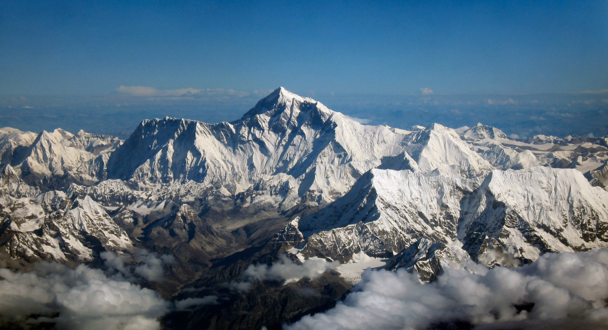Aerial view of <a href="/content/Mount_Everest" style="color:blue">Mount Everest</a> and surrounding landscape