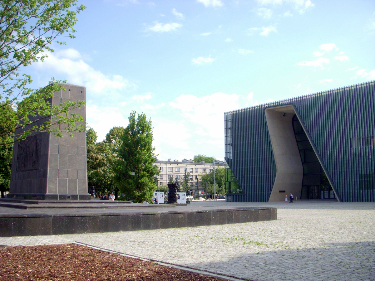 <a href="/content/POLIN_Museum_of_the_History_of_Polish_Jews" style="color:blue">POLIN Museum of the History of Polish Jews</a> (right), and <a href="/content/Monument_to_the_Ghetto_Heroes" style="color:blue">Monument to the Ghetto Heroes</a> (left), <a href="/content/Warsaw" style="color:blue">Warsaw</a> <i>Śródmieście</i>