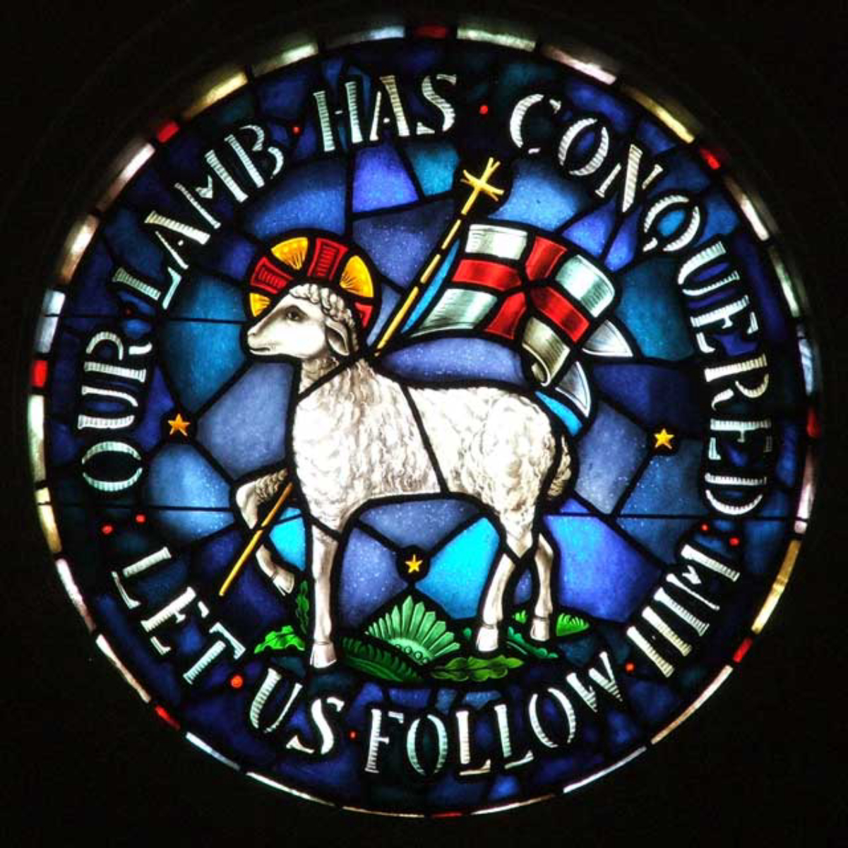 Church emblem featuring the <a href="/content/Agnus_Dei" style="color:blue">Agnus Dei</a>.Stained glass at the Rights Chapel of Trinity Moravian Church, <a href="/content/Winston-Salem,_North_Carolina" style="color:blue">Winston-Salem, North Carolina</a>, United States