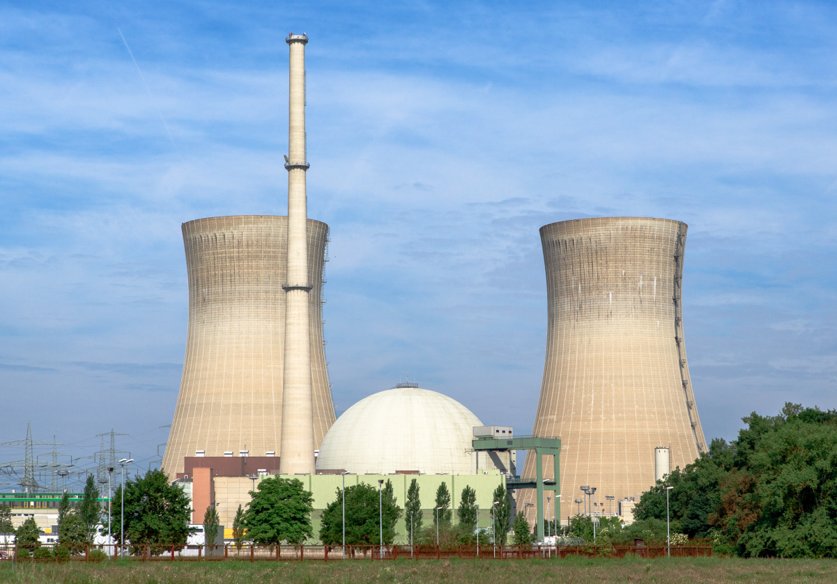 Flanked by <a href="/content/Cooling_tower" style="color:blue">cooling towers</a>, a nuclear reactor is contained inside a spherical <a href="/content/Containment_building" style="color:blue">containment building</a>