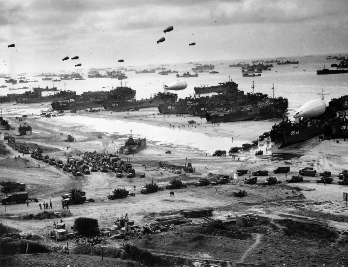 <a href="/content/Landing_Craft_Tank" style="color:blue">LCT</a> with <a href="/content/Barrage_balloon" style="color:blue">barrage balloons</a> afloat, unloading supplies on <a href="/content/Omaha_Beach" style="color:blue">Omaha</a> for the break-out from Normandy.