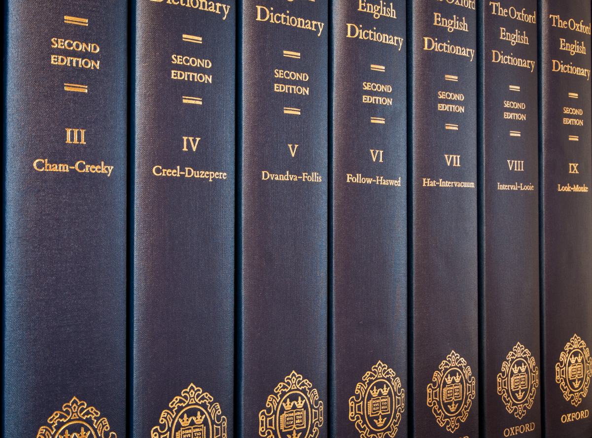 Seven of the twenty volumes of printed second edition of the <i>Oxford English Dictionary</i> (1989).