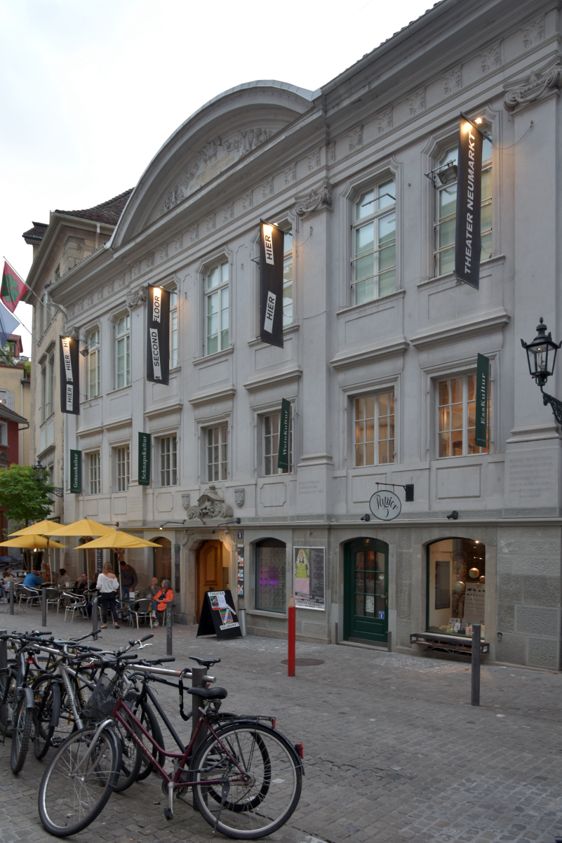 The theater building at <a href="/content/Neumarkt,_Z%C3%BCrich" style="color:blue">Neumarkt, Zürich</a>