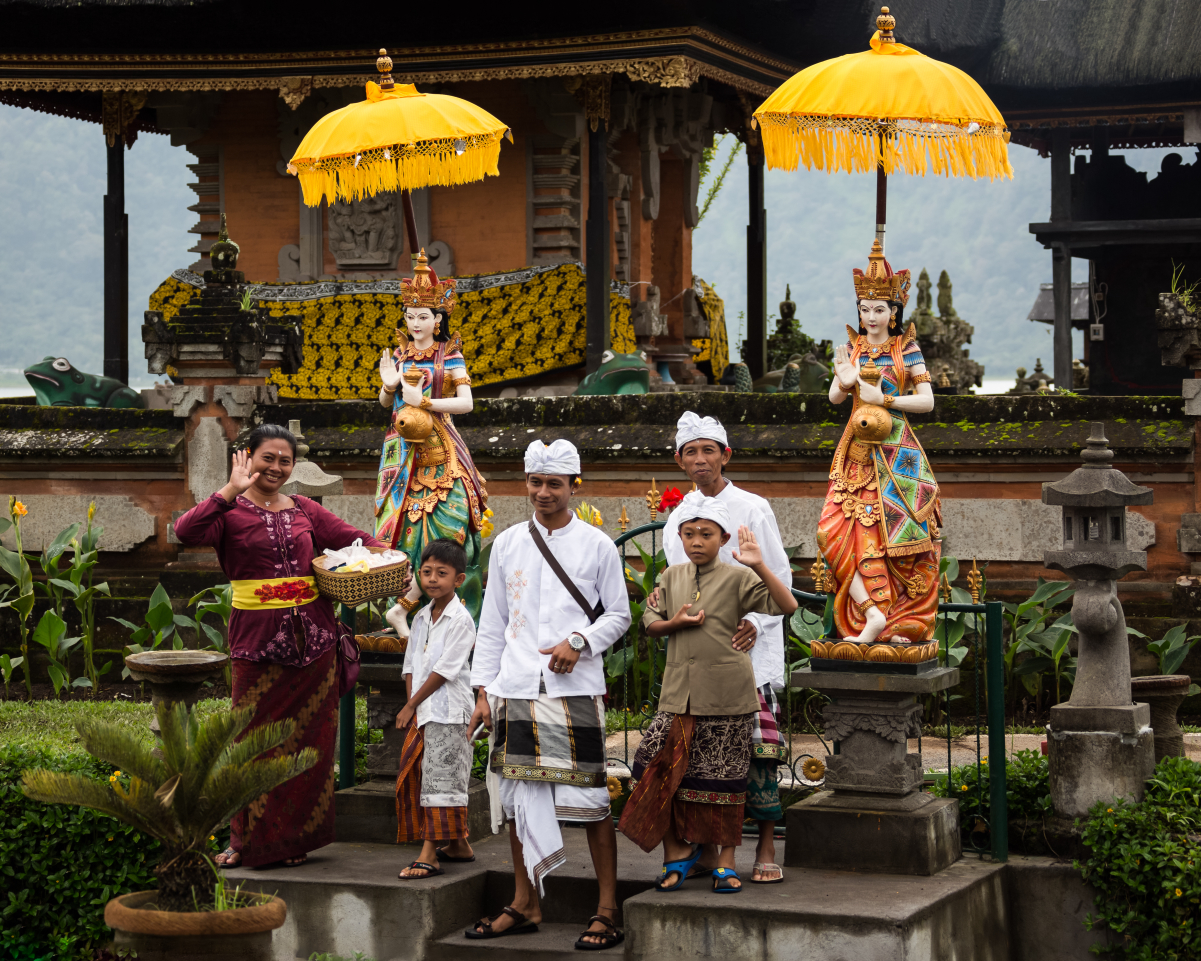 A <a href="/content/Balinese_people" style="color:blue">Balinese</a> <a href="/content/Bali_Hinduism" style="color:blue">Hindu</a> family after <a href="/content/Puja_(Hinduism)" style="color:blue">puja</a> at <a href="/content/Pura_Ulun_Danu_Bratan" style="color:blue">Bratan temple</a> in <a href="/content/Bali" style="color:blue">Bali</a>, <a href="/content/Indonesia" style="color:blue">Indonesia</a>.